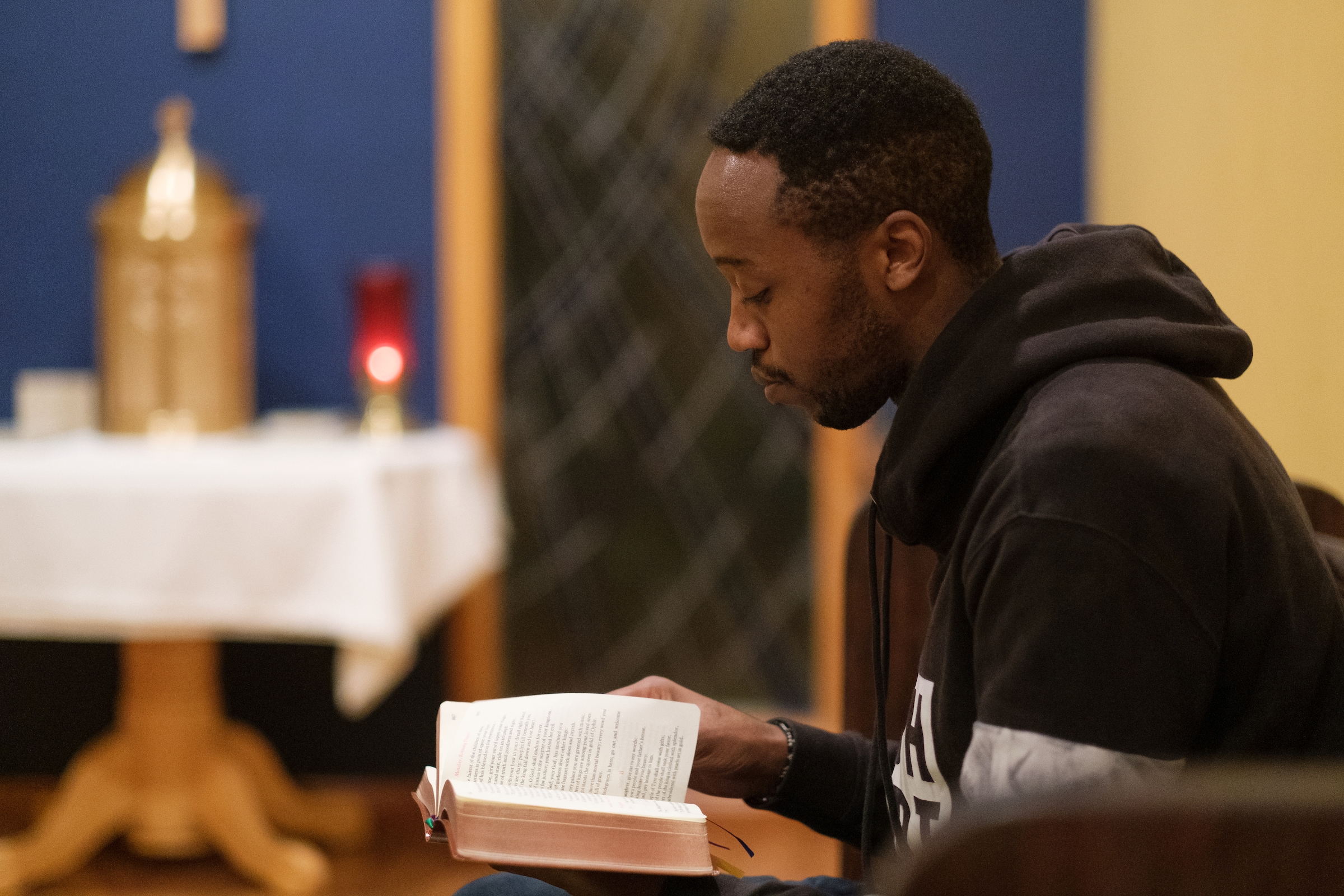 Seminarian Patrick Mbuiyu takes part in evening prayers at the Vianney House on Monday, January 21, 2019 in Seattle. (PHOTO by Stephen Brashear) Book, Chapel, Prayer