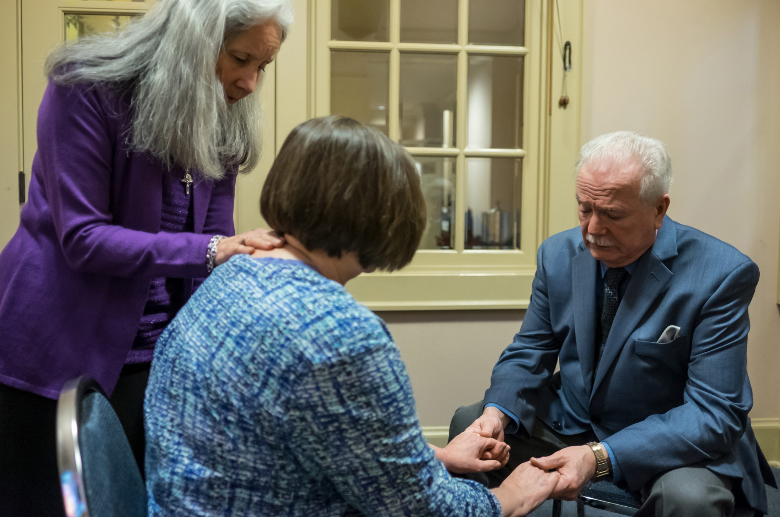 Healing Prayer Ministers John Sullivan and his wife Carmen pray with a supplicant after Mass at Our Lady of Perpetual Hope Parish Church on Sunday November 15, 2015 in Everett, Washington. (PHOTO by Stephen Brashear)
