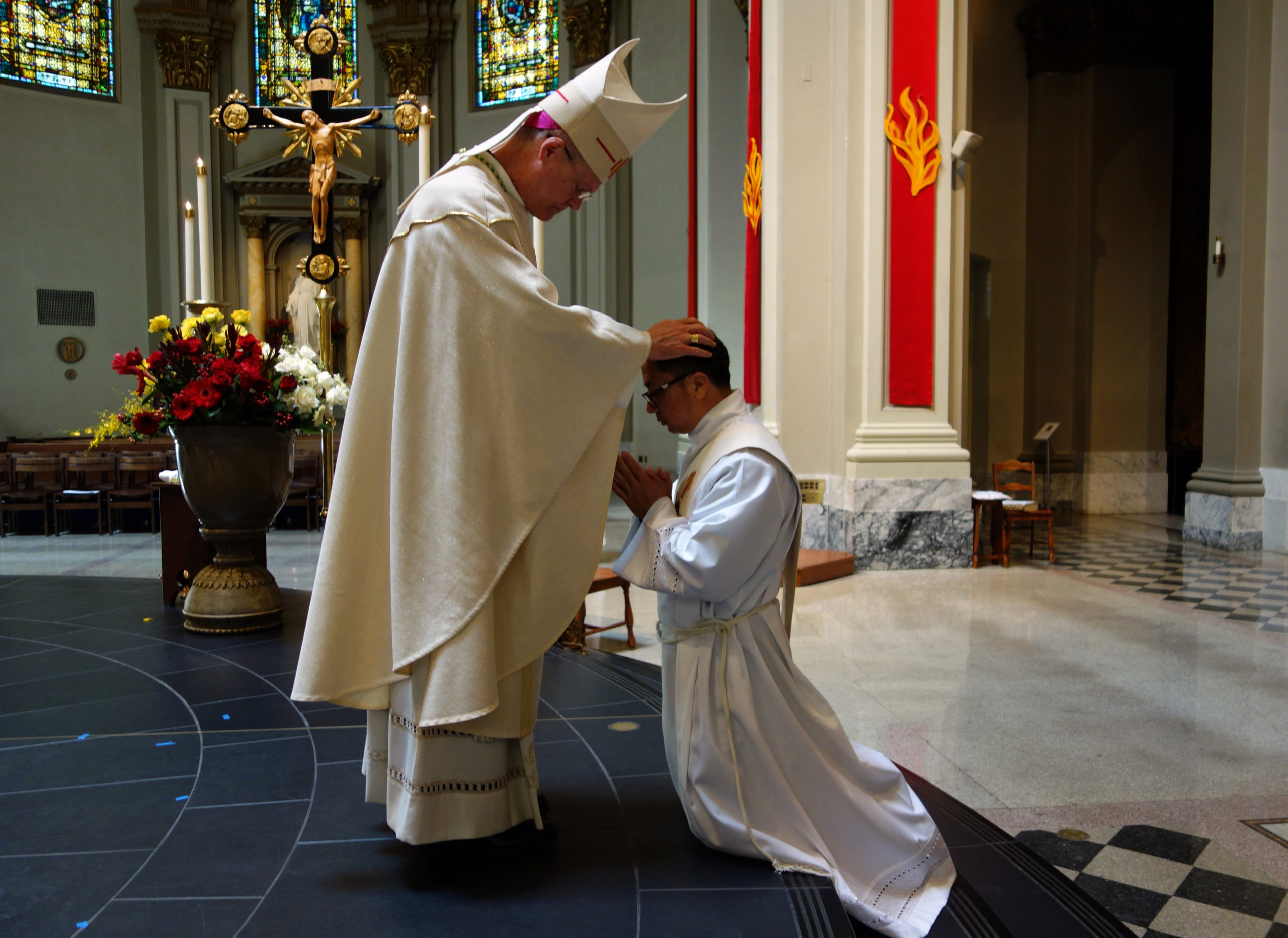 The laying on of hands by Archbishop Paul D. Etienne at the Ordination Rite of Thomas Tran, June 6, 2020 at St. James Cathedral, Seattle. Photo by M. Laughlin