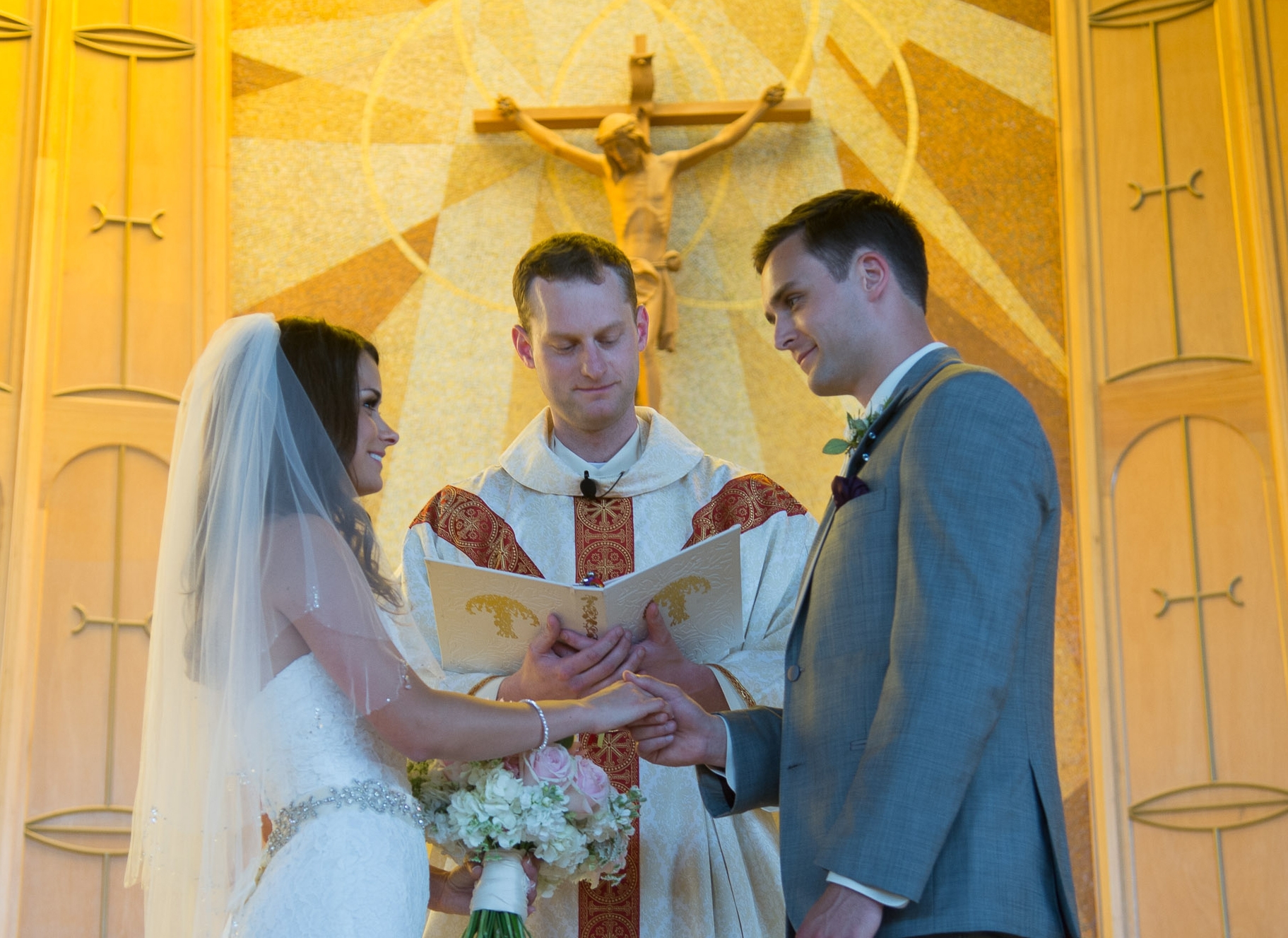 Bryce and Johnna Comfort's wedding, July 26th, 2013 at St. Charles Borromeo in Tacoma. marriage, crucifix, priest.